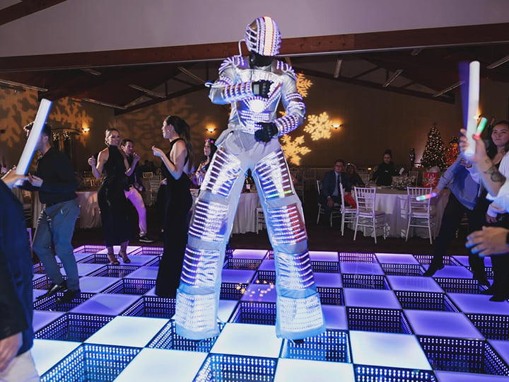 Guests dance together on the LED Robot costume