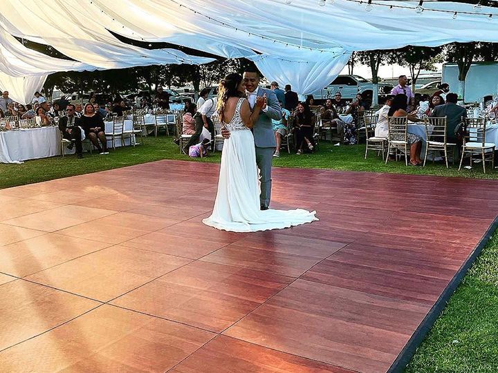 Polished-wood-dance-floor-in-outdoor-garden-wedding-setup
